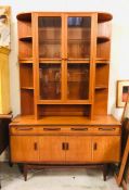 A Mid Century Display Cabinet with display shelves, glass fronted cabinets and cupboards.