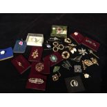 A selection of costume jewellery to include brooches, tie pins, scarves etc.
