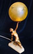 An Art Deco Lamp with a figure of a lady holding a crackle glass globe shade.