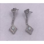 A pair of silver CZ and opal panelled art deco style earrings