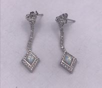 A pair of silver CZ and opal panelled art deco style earrings