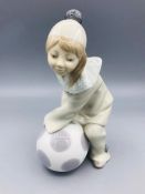 Lladro figure of a child as a clown with a ball.