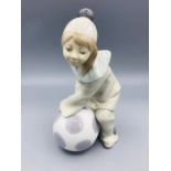 Lladro figure of a child as a clown with a ball.