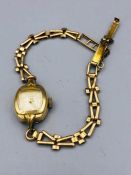 Ladies watch on a 9ct gold strap, rolled gold face. (Approx weight of strap 5g)