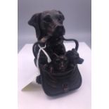 A well carved black forest inkwell in the form of a dog and her puppies