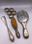 A selection of silver items to include napkin rings, dressing table mirror etc
