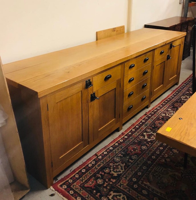 A Large Oak side board with a selection of cupboards, drawers etc 275cm Long x 72cm Deep by 86cm