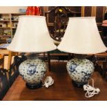 Two large Blue and White Chinese style vases on wooden bases with brass fittings.