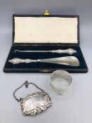 A silver napkin ring, decanter label 'Sherry' and a cased button hook and shoe horn with silver