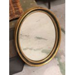 A Oval Mirror in Black and gilt plaster frame AF