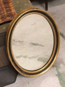 A Oval Mirror in Black and gilt plaster frame AF