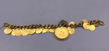 A 1911 Sovereign gold coin set on a gold charm bracelet (28.6g Total)