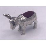 A silver pincushion in form of a donkey with ruby eyes