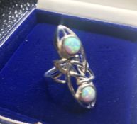 A silver art nouveau style ring with opal panels