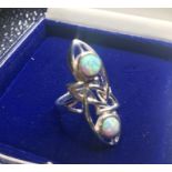 A silver art nouveau style ring with opal panels