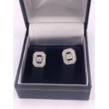 A pair of 18ct white gold diamond earrings of 1/2ct total