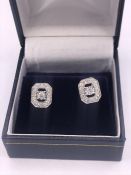 A pair of 18ct white gold diamond earrings of 1/2ct total