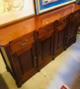 A Mahogany sideboard with four cupboards with four drawers.