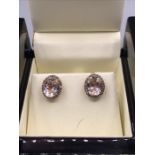 A Morganite and Diamond Earrings Two carat, oval cut Morganites (4 Carat Total) Set with a border of