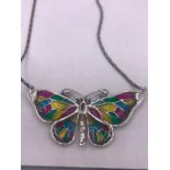 A silver plique jour butterfly necklace on silver chain