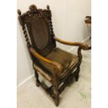A Large carved oak chair with lattice seat and back.