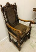 A Large carved oak chair with lattice seat and back.