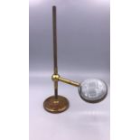 A Magnifier on a Brass stand.