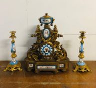 A French enamel and Ormolu clock with matching candlesticks