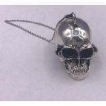 A silver skull vesta case