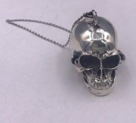 A silver skull vesta case