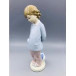 A Lladro figure of a boy with a ball.