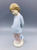 A Lladro figure of a boy with a ball.