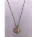 A 14ct yellow gold diamond set heart shaped pendant necklace