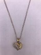 A 14ct yellow gold diamond set heart shaped pendant necklace