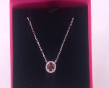 An 18ct white gold ruby and diamond pendant necklace 1/2ct on gold chain