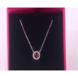 An 18ct white gold ruby and diamond pendant necklace 1/2ct on gold chain