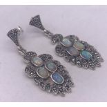 A pair of silver and opal panelled drop earrings