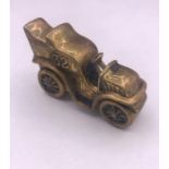 A brass vesta case in form of a vintage car