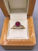 Rubellite Tourmaline and Diamond Ring 1.25ct. Oval cut Rubellite with Diamond border set in 18ct