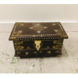 A Persian leather and brass detailed box.