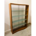 A Contemporary display unit with four glass, curved shelves. 190cm H x 140cm W