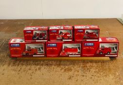 A Set Of Corgi Royal Mail Vans and a display plinth.