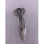 A silver bookmark with elephant finial
