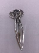 A silver bookmark with elephant finial