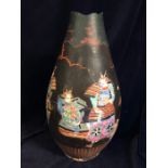 A large Chinese Famille rose vase covered in a black over material with cut outs.AF