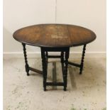 An Oak gate legged barley twist oval dining table 1920's