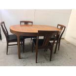 A Mid Century dining table with four leather seated chairs.