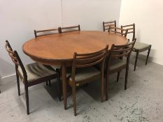 A Mid Century G Plan table with eight chairs
