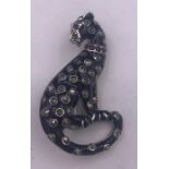 A silver and enamel leopard style brooch