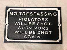 A Cast Iron sign 'No Trespassing Violators will be shot. Survivors will be shot again'